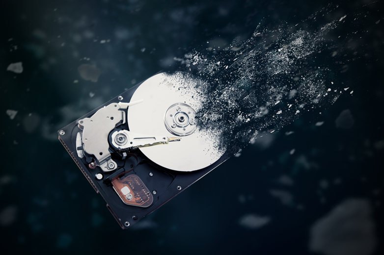 Image of old hard drive disk disintegrating in space. Concept of retrieving data from old hard drive